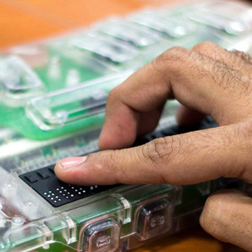 A blind person reading a refreshable braille display.